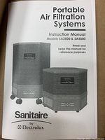 Instruction manual cover for Sanitaire portable air filtration systems Models SA2500 & SA5000 featuring product images and Electrolux branding.