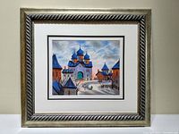 Full image of the framed serigraph showing the artwork with matting and wood frame against a light wall.