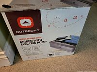 Photo of the Outbound queen double-high airbed packaging showing the product image, brand logo, and key features.