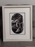 Full view of the framed print showing the Native American profile artwork in an oval design, matted and under glass.