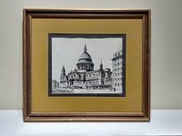 Front view of framed black and white print of St. Paul's Cathedral in London shown in wood frame and matting.