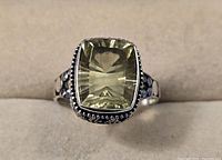 Front view showing the light green rectangular quartz stone set in a detailed Bali silver band.