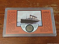 Front of plastic display case with 1922 nickel centered below Titanic ship image and historical text on orange background.