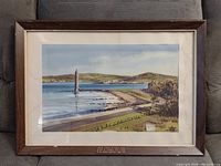 Framed watercolor artwork depicting coastal scene with tower and shoreline, by Samuel McLarnon.