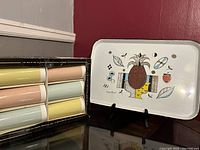 Boxed set of six pastel colored double-wall insulated tumblers alongside the Georges Briard tray