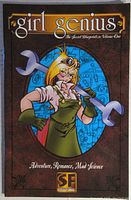 Cover of Girl Genius BluePrints Issue #1; features a blonde woman in goggles and green apron holding large wrenches on a blueprint background