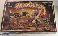 Photo of Game System box top art with fantasy battle scene and branding