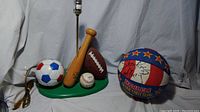 Photo of sports-themed lamp base and autographed Harlem Globetrotters basketball showing all items in the lot