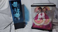 Two vintage items: Chinese dolls in display case and fiber optic flower light display.