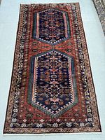Overall view of rug laid flat, showing full pattern and colors