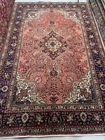 Full view of rug laid flat showing entire field and border