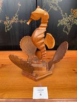 Front angle showing carved wooden seahorse on shell motif base