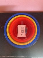 Top view of the three nested Pyrex mixing bowls in red, yellow, and blue, showing clear color distinction and bowl size progression.