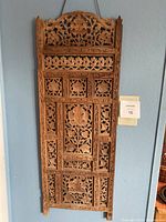 Front view of a single rectangular wooden screen panel showing all carved details and cutouts.
