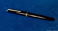 Full side view of the Montblanc 221 black fountain pen showing the gold trim and black resin body.
