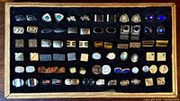 Full view of the tray displaying 35 pairs of vintage men's cufflinks in various designs and materials