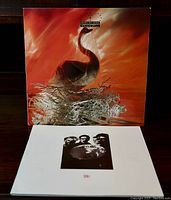 Front cover of the Depeche Mode Speak & Spell vinyl album with the Music for the Masses tour book laid flat below it showing its black and white cover photo.