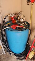 Full view of the mounted Ingersoll Rand ARO pump on the blue 200L drum with attached fuel hose and dispensing nozzle.