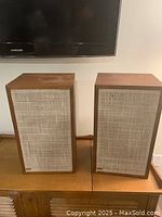 Pair of Dynaco A-25 speakers front view showing wood cabinets and cloth grilles