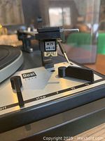 Close-up of the tonearm area showing the Shure M71 MB-D cartridge with Dual 1214 branding and speed slider controls.