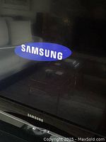 Samsung logo on front of TV showing brand and frame details.
