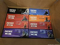 Eight Fortnite McFarlane Toys action figure boxes in a cardboard shipping box; top row Wild Card and The Ice King; second row Havoc and The Prisoner; third row two Inferno; bottom row two Dire.