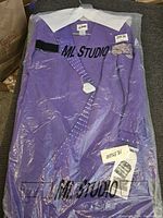 Full view of the ladies purple outfit in plastic packaging, showing the ML Studio branding on the cover and visible white collar.
