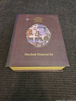 Closed box showing 'The Nightmare Before Christmas Storybook Ornament Set' with movie characters on the cover.