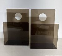 Front view of two smoked plexiglass holders side by side showing the circular cutout handles and open fronts.