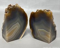 Front view of the two agate geode bookends, showing polished fronts with natural banding