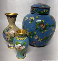 Front view of all three cloisonne items showing overall condition and designs on vases and ginger jar.