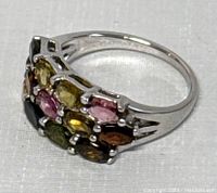Side angle of silver ring showing colorful gemstones and band split design, marked 925.