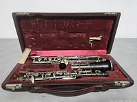Open hard case showing five-piece clarinet and accessories