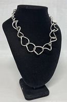 Front view of necklace draped on black display bust