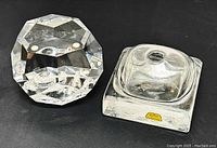 Two glass items side by side: Moser crystal paperweight with faceted design and Rosenthal glass inkwell with label.