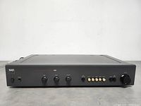 Front view of the NAD Monitor Series Stereo Preamplifier 1000 showing the control panel with various knobs and buttons for audio adjustments and input selection.