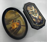 Both the oval lacquer tray and the octagonal lacquer box, showing hand painted scenes on each item
