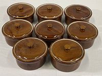 Photo showing all eight covered ramekins arranged together highlighting uniform design and color.