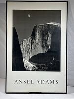 Full view of the framed black and white poster showing Half Dome and moon with Ansel Adams text beneath