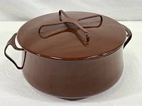 Brown enamel Dansk Kobenstyle covered casserole pot photographed with lid on. Shows pot shape, color, and side handles.