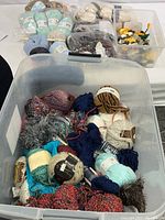 Large bin with a diverse assortment of yarn skeins and balls in multiple colors and textures.