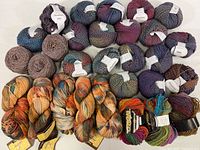Overview of all skeins and hanks arranged on a white surface