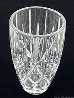 Full view of the large crystal vase showing cut star and spear designs on transparent body