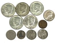 Mixed group of older U.S. coins including nickels from 1945, a Buffalo nickel and other older smaller coins arranged with front side showing.
