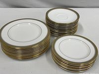 Sets of stacked plates and saucers showing different sizes and quantities in the partial Royal Doulton Clarendon collection.