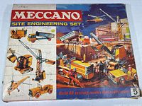 Front of box showing site engineering construction models such as tractor, tipping truck, builders crane, jeep, excavator, and helicopter in colorful illustrations with branding.