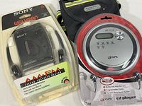 Lot from a higher angle showing item details: Sony Walkman, GPX CD player, Sportline case