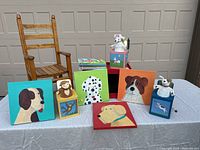 Full set up of children's items including rocking chair, jack-in-the-box toys, artwork, and chalkboard bin.