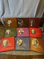 Nine boxed record sets from the Great Men of Music series by Time Life, arranged on the floor showing the portraits of composers on the front covers.