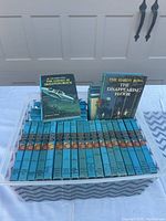 Front view of Hardy Boys books laid in bin with two books up front showing titles
